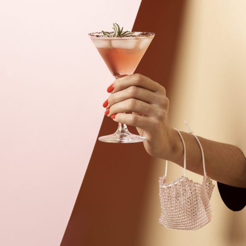 Hand holding a cocktail